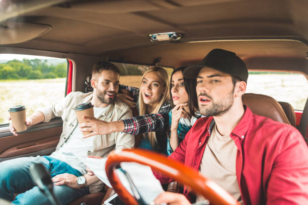 istock group of young people planning car journey and looking forward 1017887926