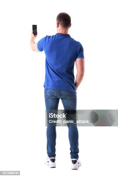 Rear View Of Modern Adult Casual Man Taking Photo With Smart Phone Stock Photo - Download Image Now