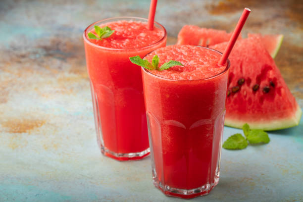 istock Watermelon slushie with lime, summer refreshing drink in tall glasses on a blue rusty background. with copy space 1017891032