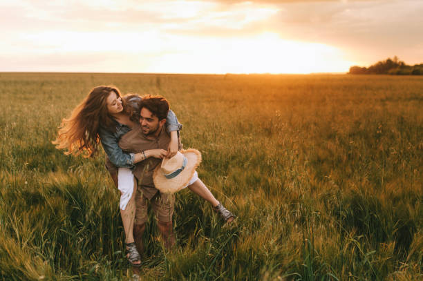 istock boyfriend piggybacking his beautiful girlfriend on summer meadow 1017900904