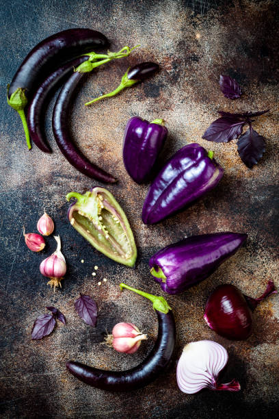 istock Raw purple seasonal vegetables over rustic background. Top view, flat lay 1017906392