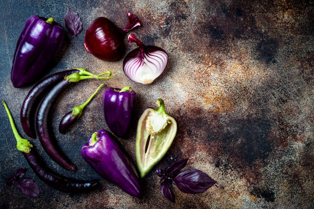 istock Raw purple seasonal vegetables over rustic background. Top view, flat lay 1017906394