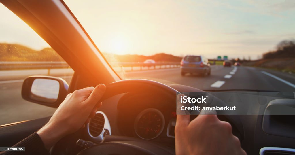 hands of car driver on steering wheel, road trip hands of car driver on steering wheel, road trip, driving on highway road Car Stock Photo