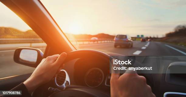 Hands Of Car Driver On Steering Wheel Road Trip Stock Photo - Download Image Now - Car, Highway, Road