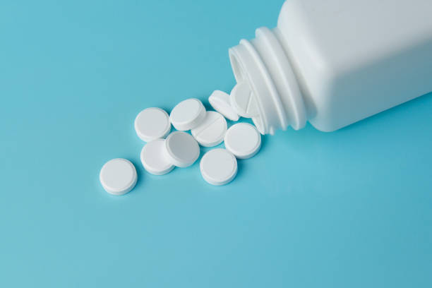 Pills on a blue background. Pills poured from the container aspirin photos stock pictures, royalty-free photos & images