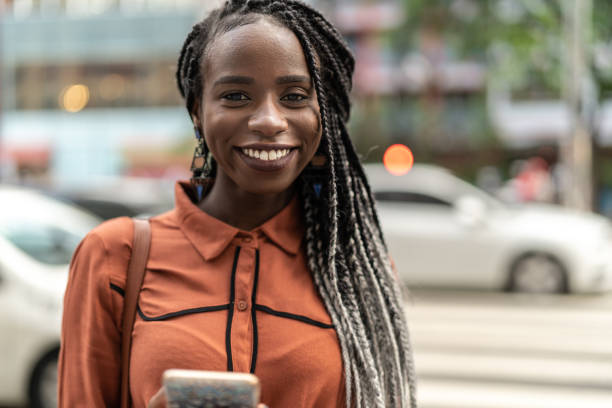 istock Afro Woman Using Mobile at Street 1017936688