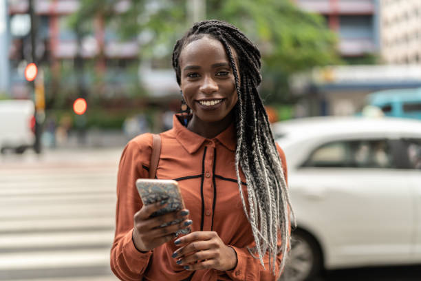 istock Afro Woman Using Mobile at Street 1017936724