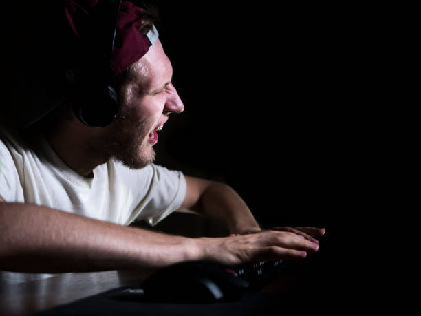 istock crazy mad game addict playing video games in the night 1017958580