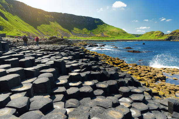 Giants Causeway, an area of hexagonal basalt stones, created by ancient volcanic fissure eruption, County Antrim, Northern Ireland. Giants Causeway, an area of hexagonal basalt stones, created by ancient volcanic fissure eruption, County Antrim, Northern Ireland. Famous tourist attraction, UNESCO World Heritage Site. giants causeway photos stock pictures, royalty-free photos & images