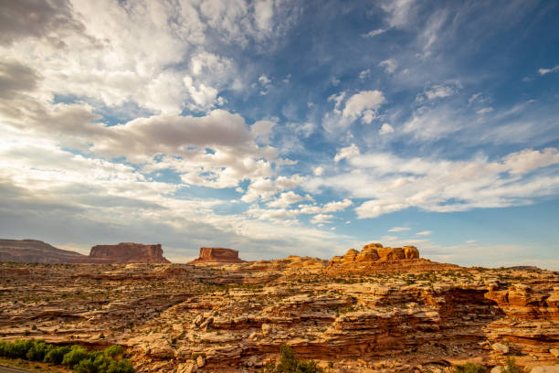 istock Scenic view of butte, rock formations, blue sky and white clouds 1017979296