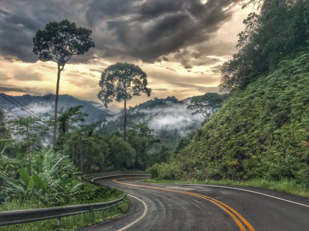 istock A Curved asphalt road goes down from a hill 1017984168