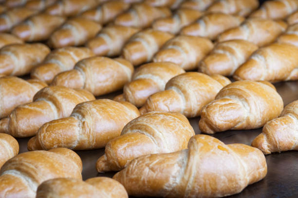 istock Baked croissants group on the production line 1017997126