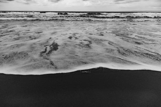 istock Black sand volcano on the ocean / sea beach. 1018003334