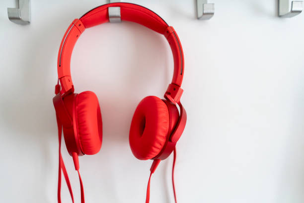 The headphones in a female hands through the holes