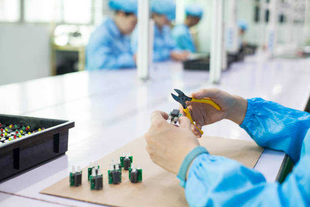istock Worker holding diode at a LED lighter factory in Dongguan, China 1018041140