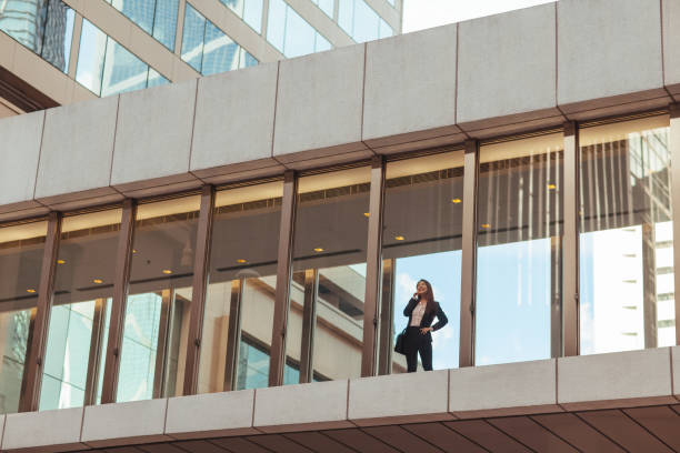 istock Business woman standing on pedestrian bridge 1018041262