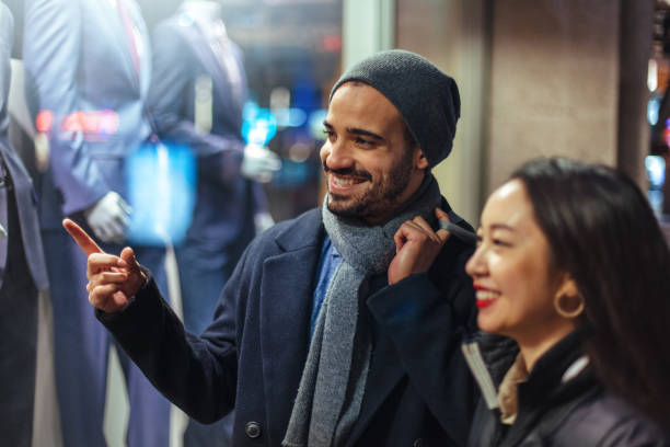 istock Couple window shopping outdoors in winter 1018047612