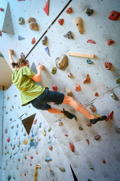 istock Teenage Boy Training Climbing On Indoor Climbing Wall 1018062108
