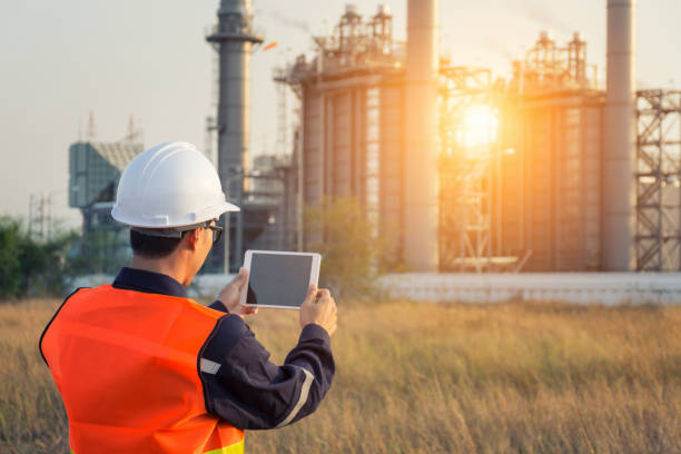 Engineer working with tablet PC near power plant Engineer working with tablet PC near power plant af_istocker stock pictures, royalty-free photos & images
