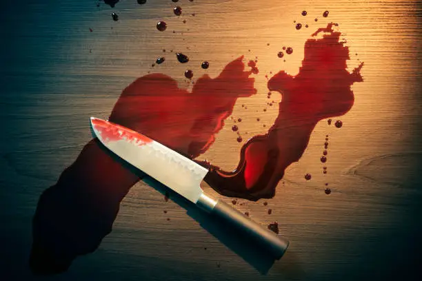 Photo of Bloody crime scene with knife on the floor