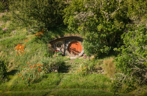 The red door Hobbit hole in Hobbiton movie set in Matamata, New Zealand. Matamata, New Zealand - December 09 2017 : The red door Hobbit hole in Hobbiton movie set in Matamata, New Zealand. matamata new zealand stock pictures, royalty-free photos & images