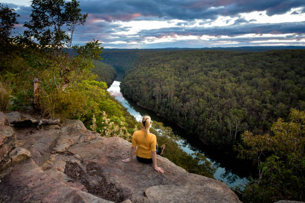 istock Female admiring beautiful river views from mountain cliff tops 1018081590