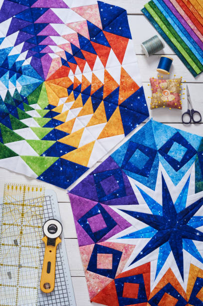istock Fragments of quilt, accessories for patchwork, top view on a white wooden surface 1018082082