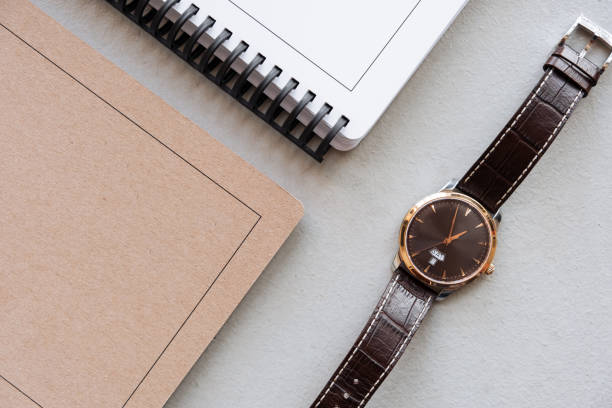 istock Selective focus table : Businessman hand write notebook, mobile phone, laptop, and pen on the wooden table.working Business concept 1018082102