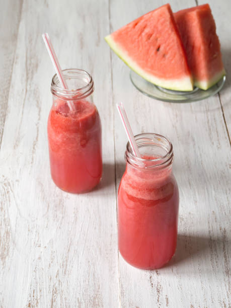 istock Watermelon smoothie on a white wooden table. 1018082284