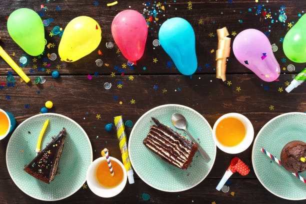 istock Top view children birthday table Chocolate cake and decoration party 1018091484