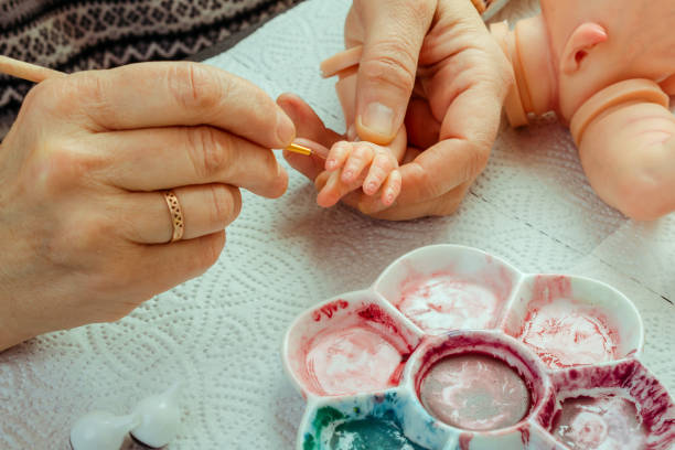 istock Female hands make dolls of BJD or reborn in the workplace. Processing the workpiece. The concept of the craft of the master manufacturer of dolls. Selective focus. 1018092236