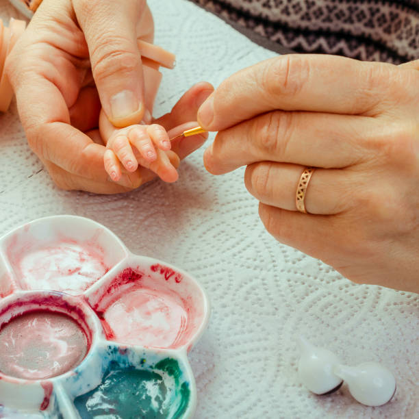 istock Female hands make dolls of BJD or reborn in the workplace. Processing the workpiece. The concept of the craft of the master manufacturer of dolls. Selective focus. For instagram format. 1018092474