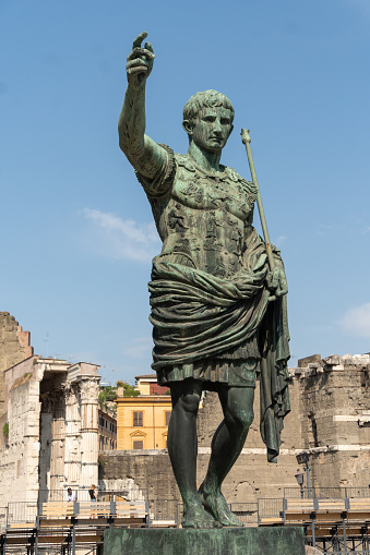 Julius Caesar statue with church of Saint Luca e Martina on the background - a bronze copy of the statue in the Capitol
