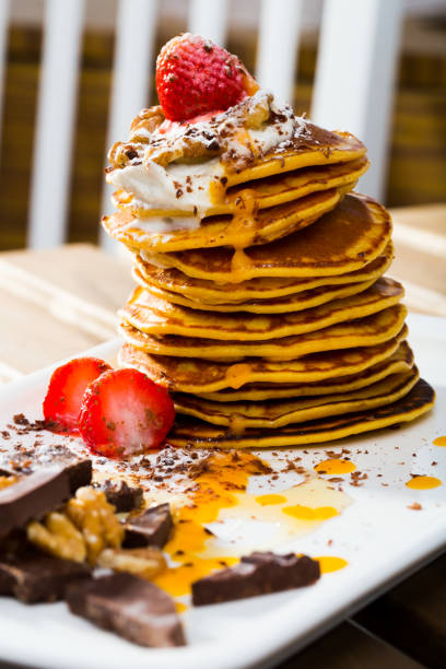 istock Stack of sweet pancakes with  fruit, honey, chocolate and whipped cream 1018099046