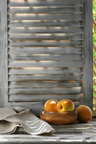 istock Peaches in bowl and napkin on old windowsill 1018103508