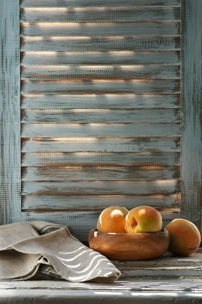 Peaches in bowl and napkin on old windowsill