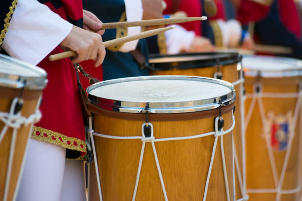 istock Group of Men Dressed in Medieval Clothes Playing Drums in Italy 1018109552