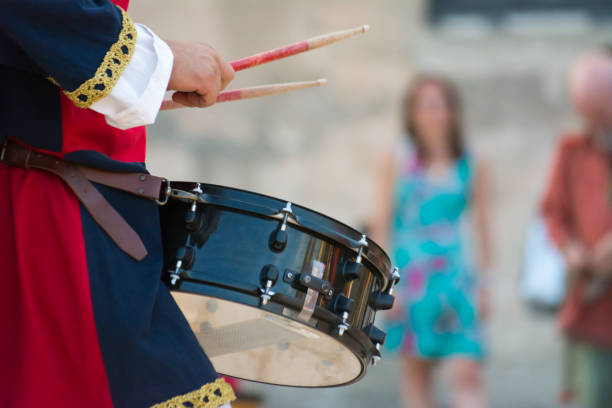 istock Man Dressed in Medieval Clothes Playing Drum in Italy 1018126534