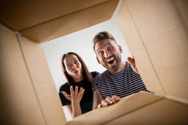 istock The couple unpacking and opening carton box and looking inside 1018131290