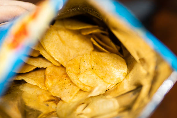 istock Sour cream and onion flavored potato chips in bag 1018139038