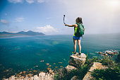 Woman Hiking In Seaside Taking A Selfie