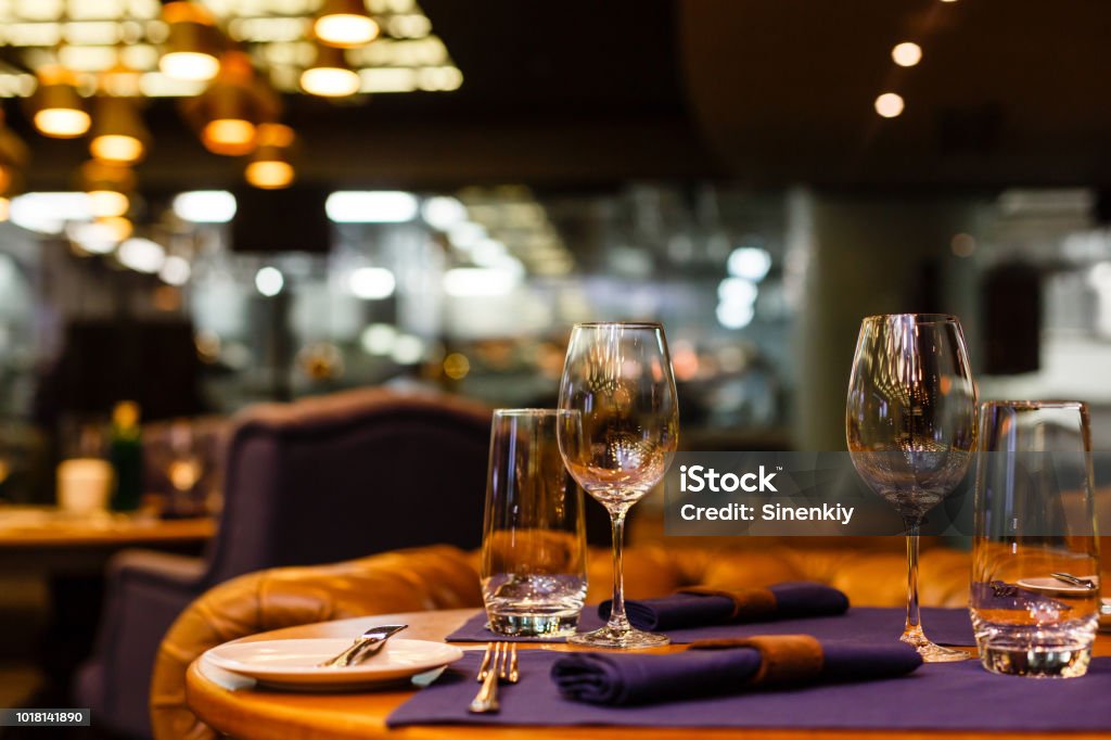 Two empty wine glasses sitting in a restaurant on a warm sunny afternoon. Restaurant Stock Photo