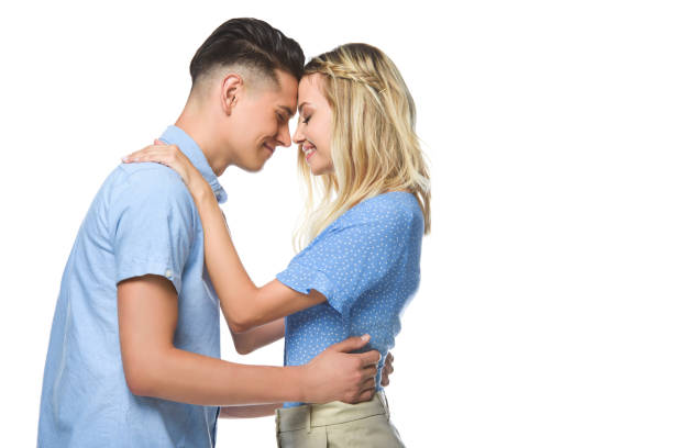 istock couple in blue shirts hugging and touching with foreheads isolated on white 1018142598