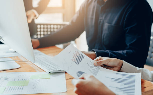 istock Businessmen are working together to analyze the graph in the office. 1018142808