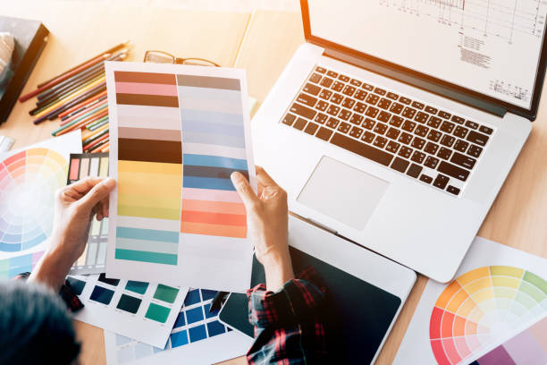 istock Top view of designer working at his desk about choosing colors. 1018142890