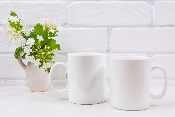 istock Two white coffee mug mockup with viburnum flowers 1018143408