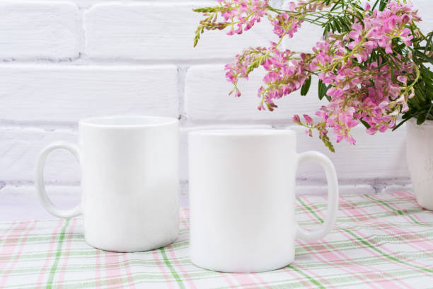 istock Two coffee mug mockup with small pink flowers 1018143436