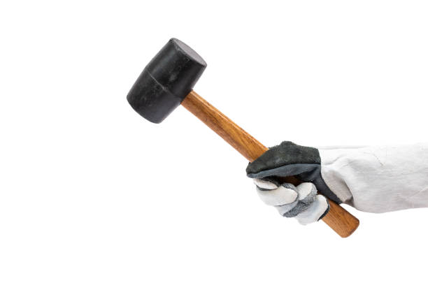 istock hand holding rubber hammer isolated on white background 1018144196