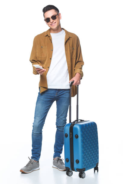 istock happy young man with luggage and smartphone isolated on white 1018145994