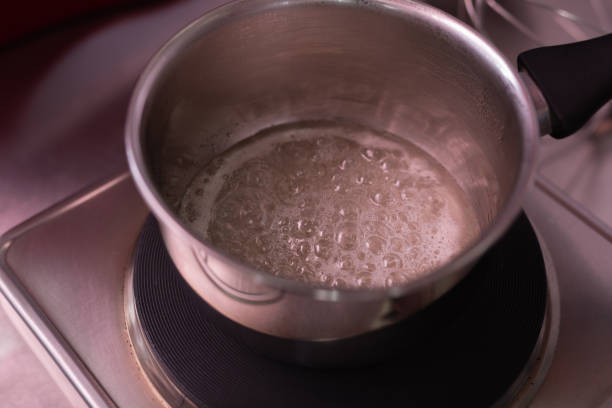 istock Professional baker warming whites of egg for cooking meringue 1018151504